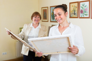 Two women staging a home with art